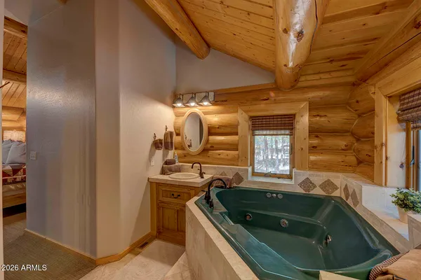 a bathroom with a tub sink and mirror