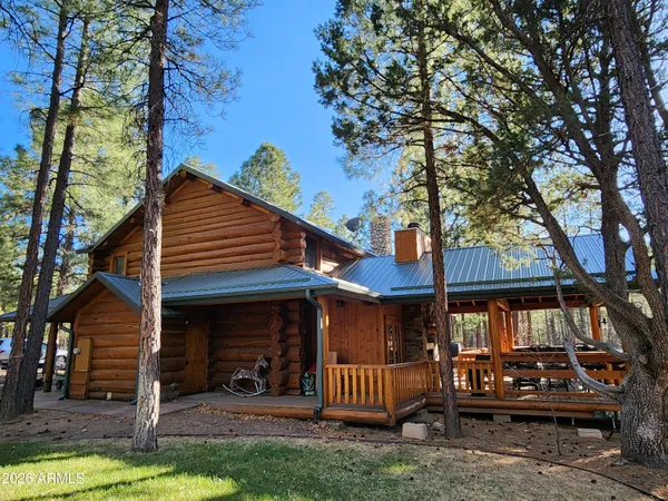 a view of a house with a yard porch and furniture