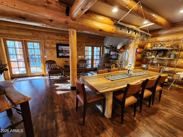 a dining room with furniture window and wooden floor
