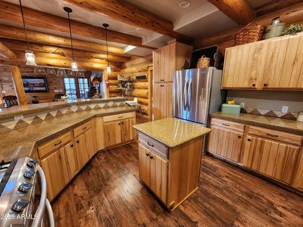 a kitchen with stainless steel appliances granite countertop a sink a stove and a refrigerator