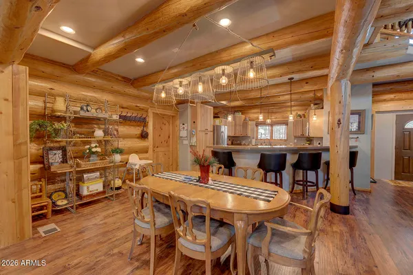 a dining room with a wooden table and chairs