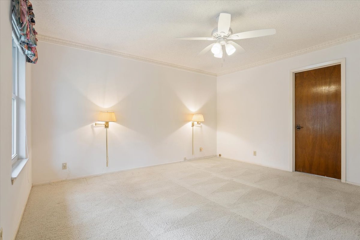 4015 Ramada Trail Georgetown, TX 78628 - Photo 18 of 35 Spare room featuring a textured ceiling, ceiling fan, light colored carpet, and crown molding