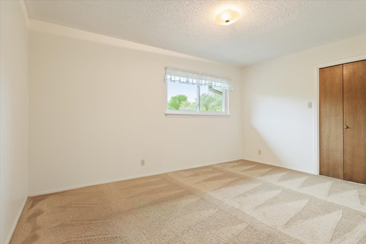 4015 Ramada Trail Georgetown, TX 78628 - Photo 25 of 35 Unfurnished bedroom with carpet floors and a textured ceiling