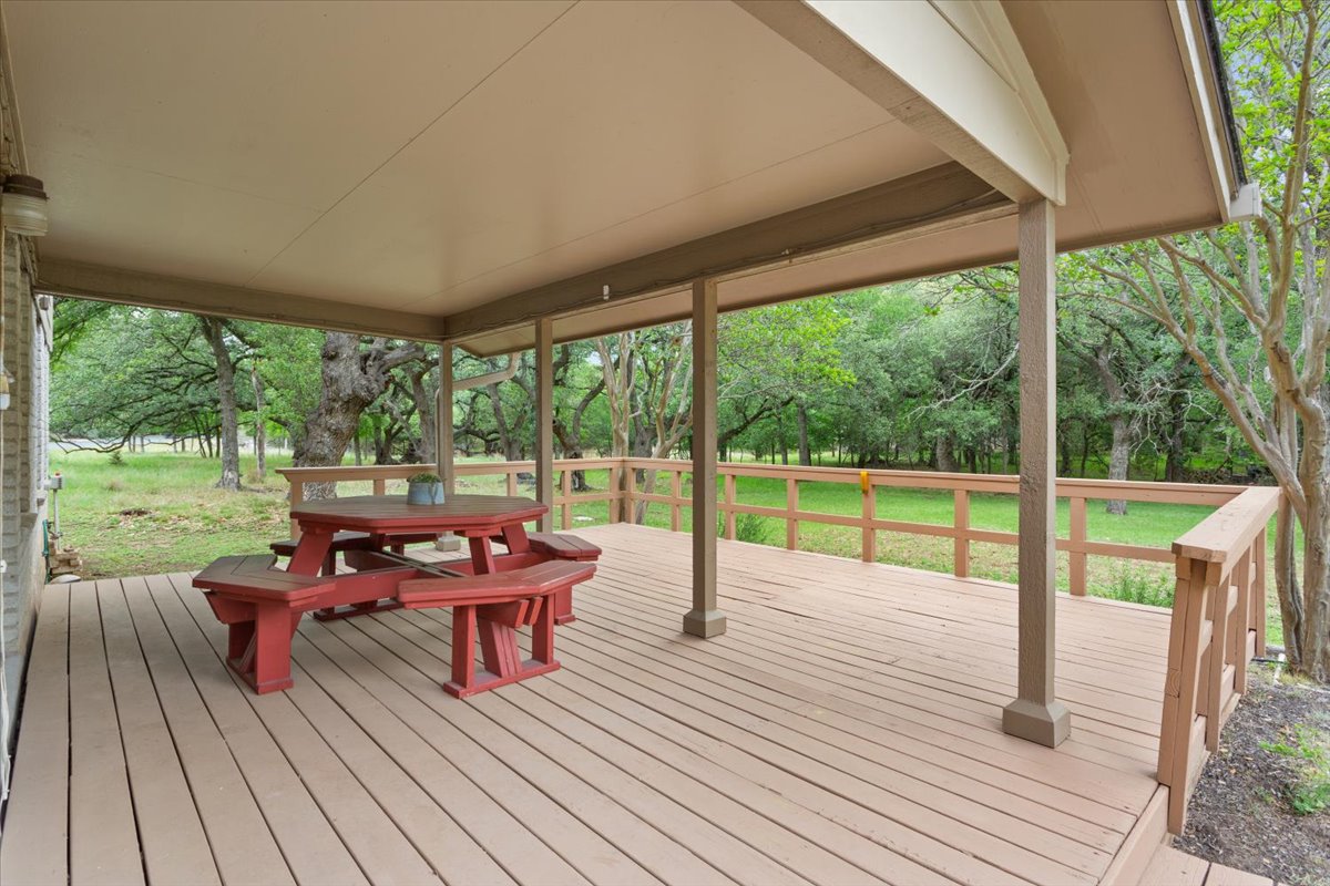 4015 Ramada Trail Georgetown, TX 78628 - Photo 30 of 35 Wooden terrace featuring outdoor dining space and a yard