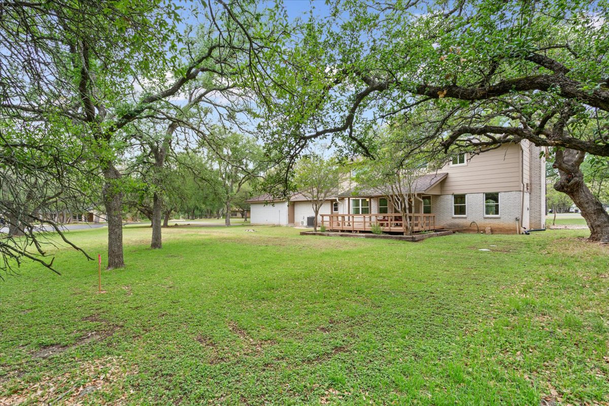 4015 Ramada Trail Georgetown, TX 78628 - Photo 32 of 35 View of grassy yard with a wooden deck
