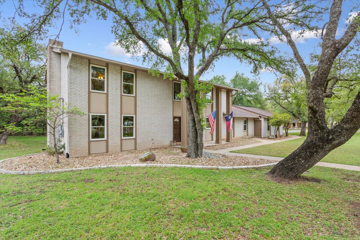 4015 Ramada Trail Georgetown, TX 78628 - Photo 6 of 35 View of front of property with a front lawn, brick siding, and a chimney