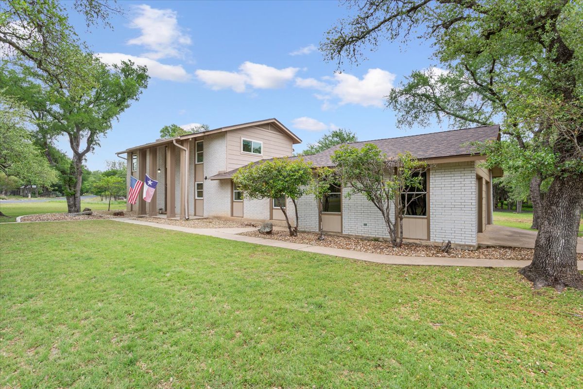4015 Ramada Trail Georgetown, TX 78628 - Photo 7 of 35 Back of house with a yard and brick siding