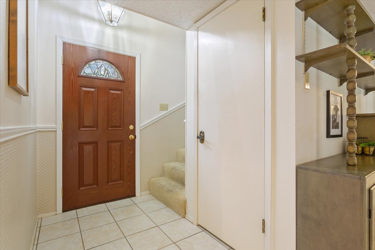 4015 Ramada Trail Georgetown, TX 78628 - Photo 10 of 35 Entryway with wainscoting and light tile patterned floors
