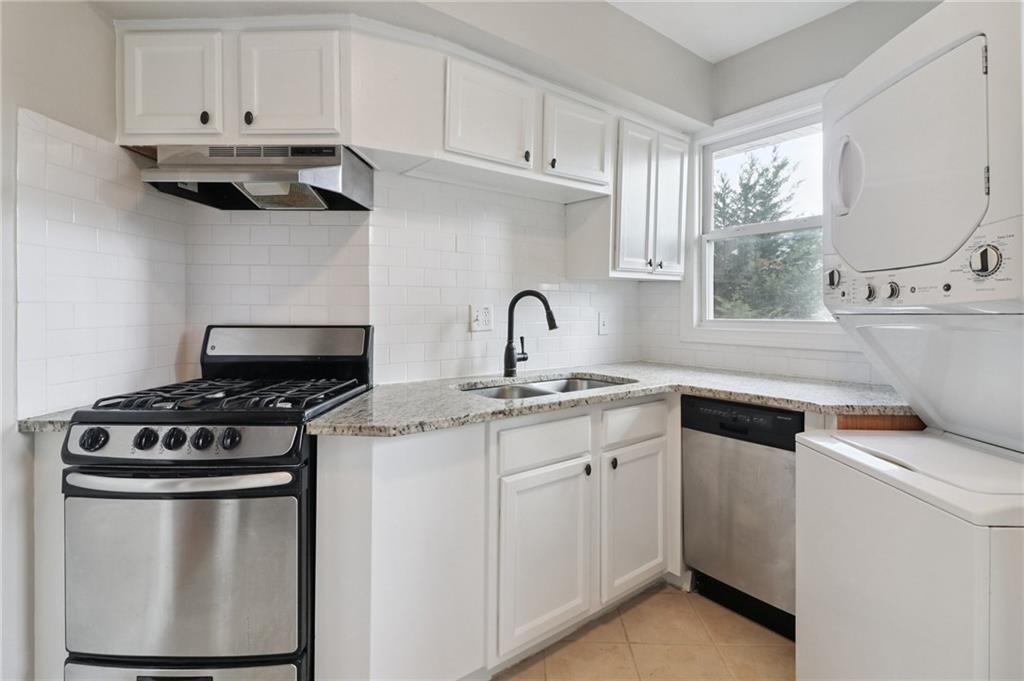 2477 North Decatur Road, Unit B4 Decatur, GA 30033 - Photo 4 of 25 a kitchen with granite countertop white cabinets and white appliances