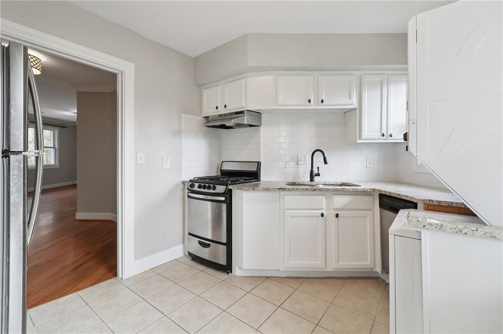 2477 North Decatur Road, Unit B4 Decatur, GA 30033 - Photo 5 of 25 a kitchen with stainless steel appliances granite countertop a sink and a stove