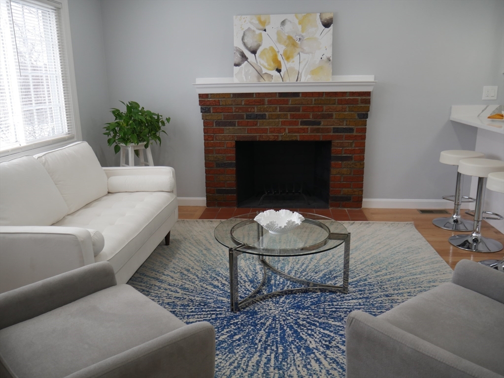 54 Harris Road Lynn, MA 01904 - Photo 13 of 41 a living room with furniture and a fireplace