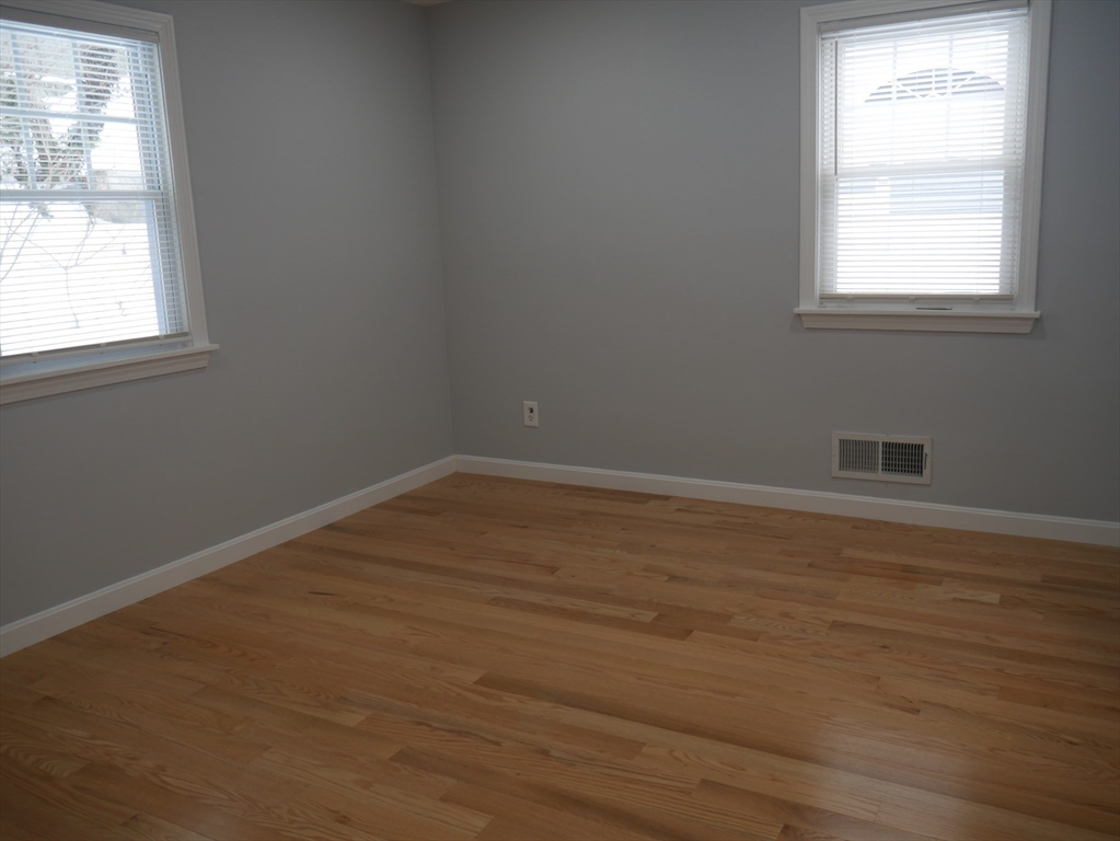 54 Harris Road Lynn, MA 01904 - Photo 25 of 41 an empty room with wooden floor and windows