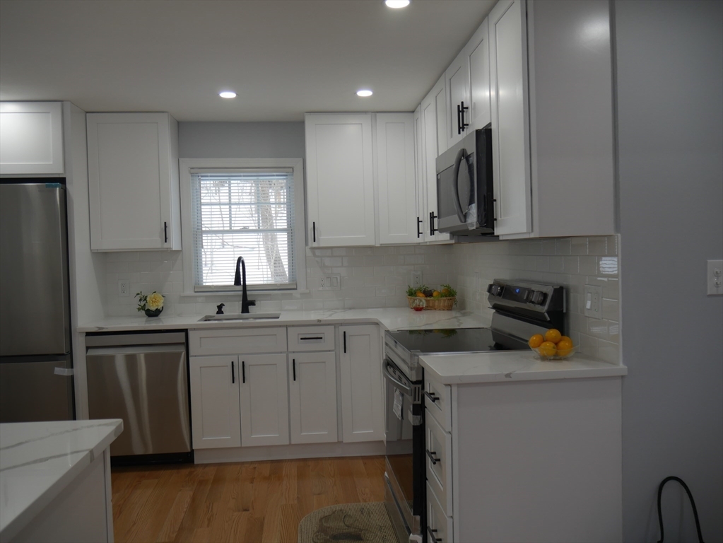 54 Harris Road Lynn, MA 01904 - Photo 4 of 41 a kitchen with a sink cabinets and window
