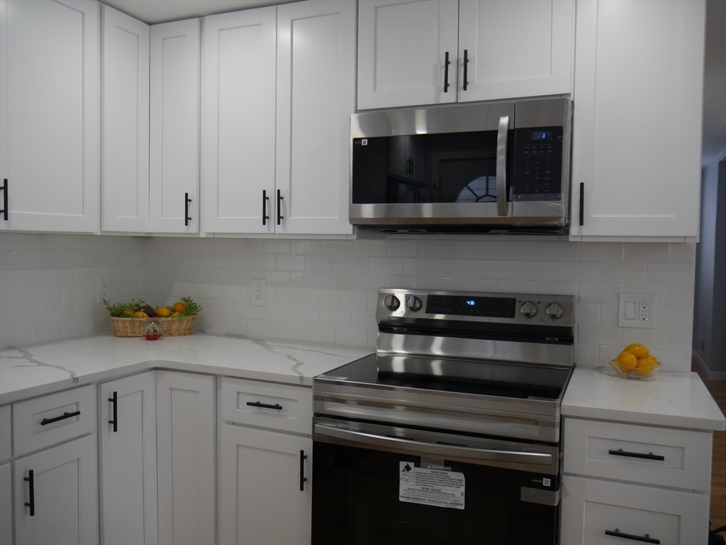 54 Harris Road Lynn, MA 01904 - Photo 8 of 41 a kitchen with a stove and a microwave