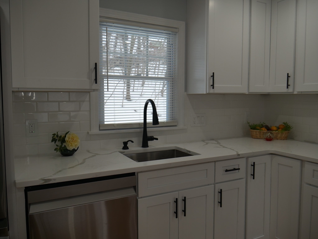 54 Harris Road Lynn, MA 01904 - Photo 10 of 41 a kitchen with a sink cabinets and window