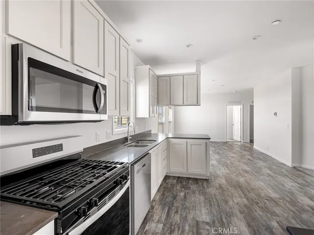 a kitchen with granite countertop a stove and a microwave