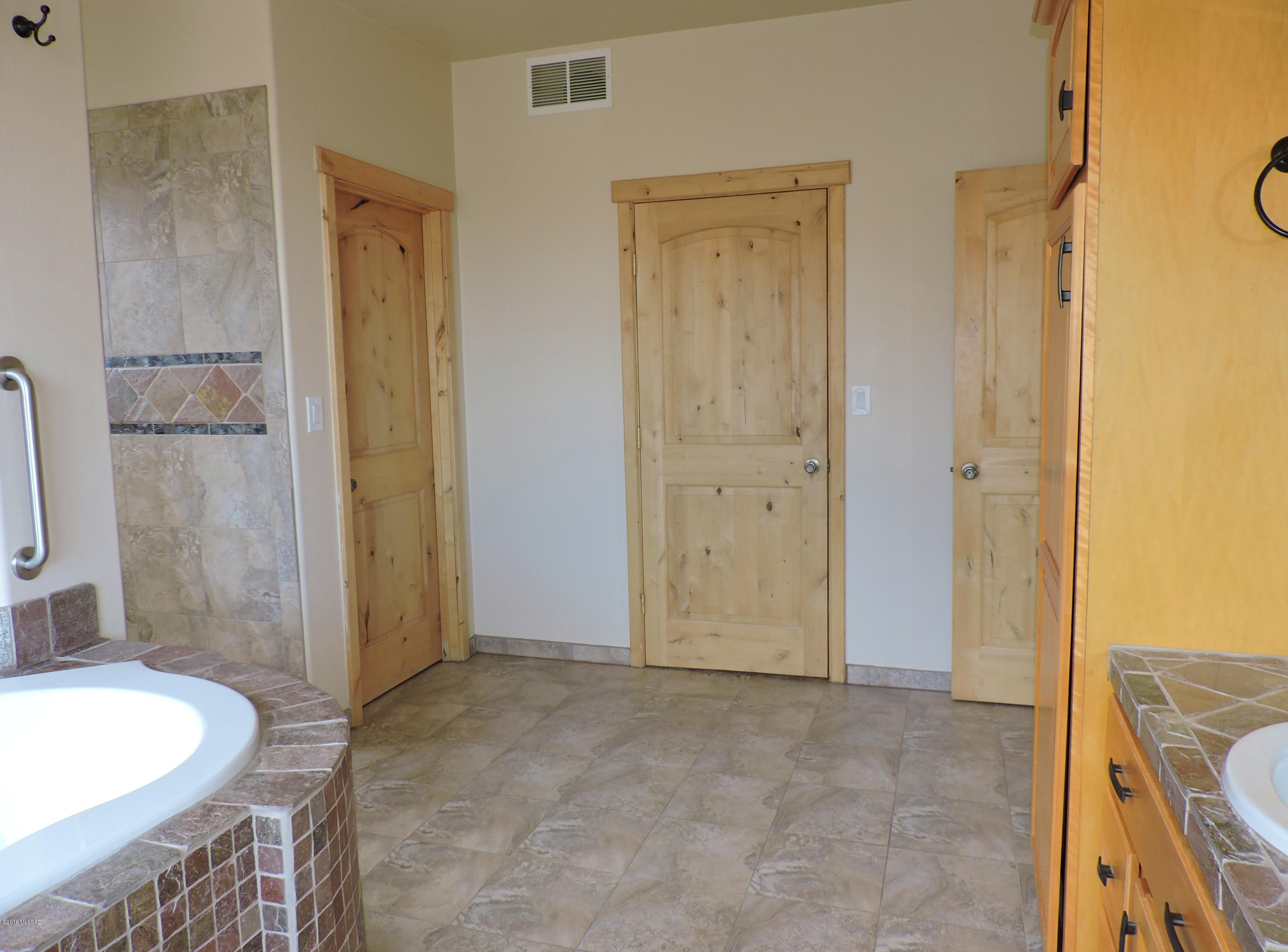1716 Ave Calamar Rio Rico, AZ 85648 - Photo 25 of 36 a bathroom with a granite countertop sink and a mirror
