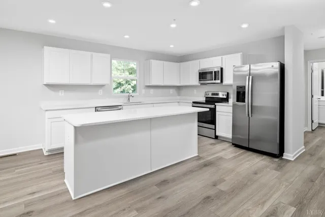 a kitchen with stainless steel appliances a refrigerator sink and microwave