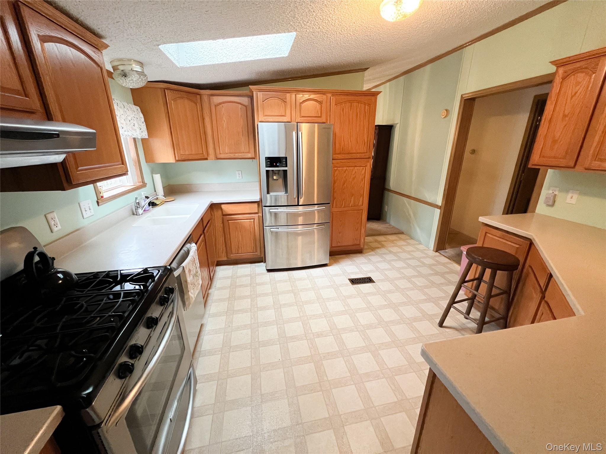 509 Burnwood Road East Branch, NY 13756 - Photo 6 of 14 a kitchen with a stove a refrigerator and a sink