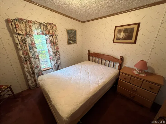 a bed sitting in a bedroom next to a window