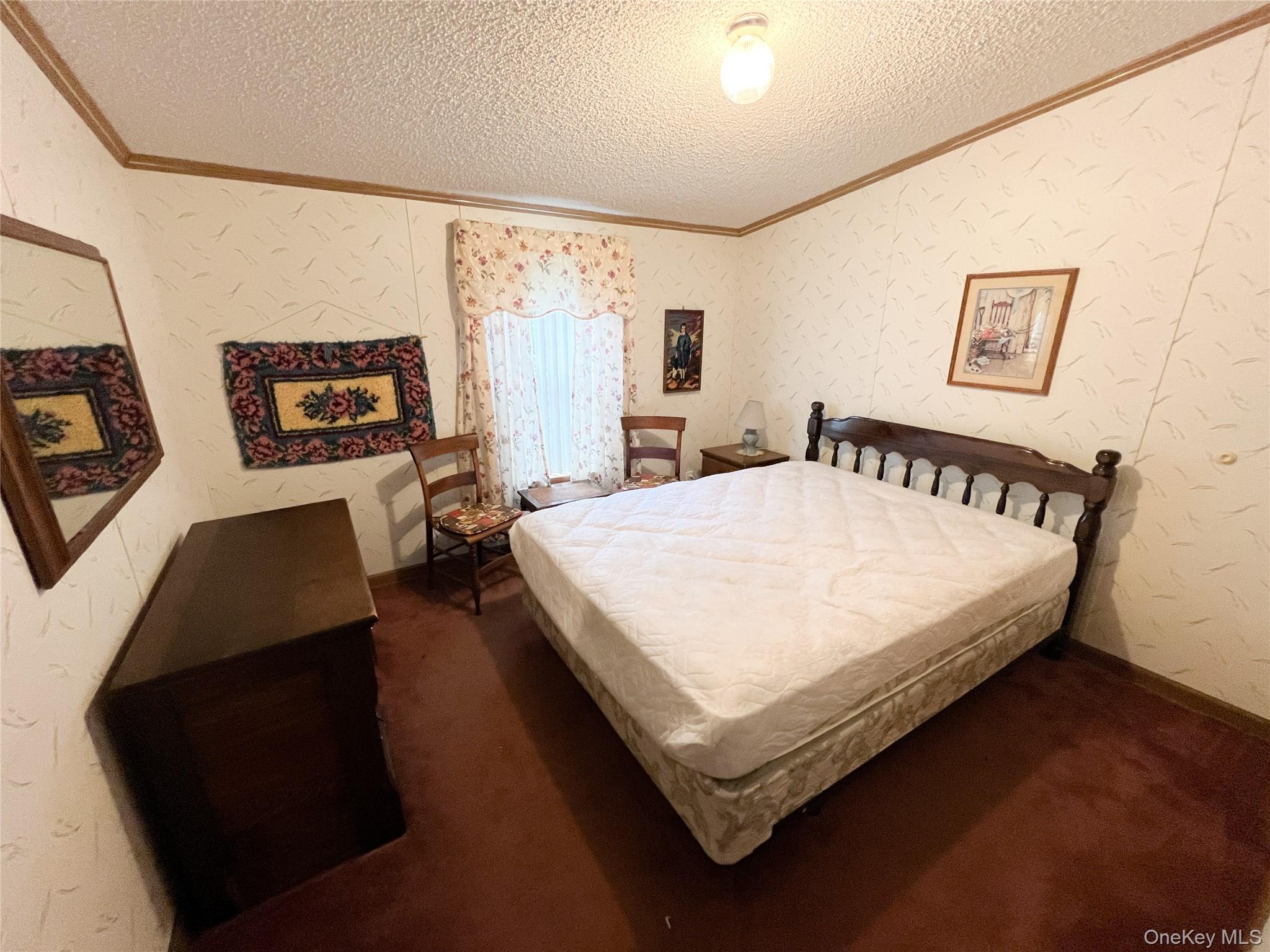 509 Burnwood Road East Branch, NY 13756 - Photo 10 of 14 a bed sitting in a bedroom next to a window with wall paintings and a wooden floor