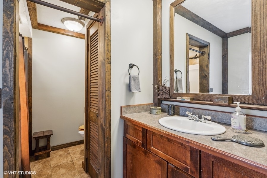 28W740 Army Trail Road West Chicago, IL 60185 - Photo 14 of 24 a bathroom with a granite countertop sink and a mirror