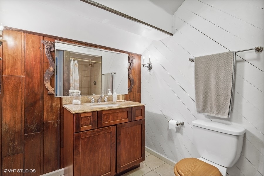 28W740 Army Trail Road West Chicago, IL 60185 - Photo 19 of 24 a bathroom with a sink a toilet and shower