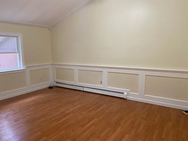 a view of a kitchen with wooden floor and electronic appliances