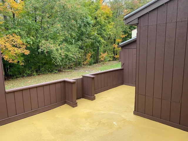 a view of balcony with wooden fence