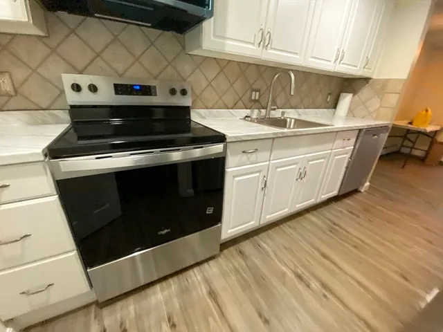 a kitchen with a sink and cabinets
