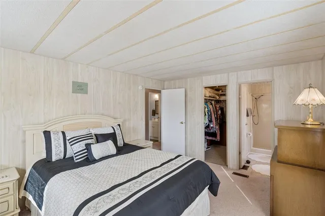 a bedroom with a bed and a mirror