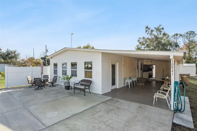 a view of a house with backyard sitting area and garden