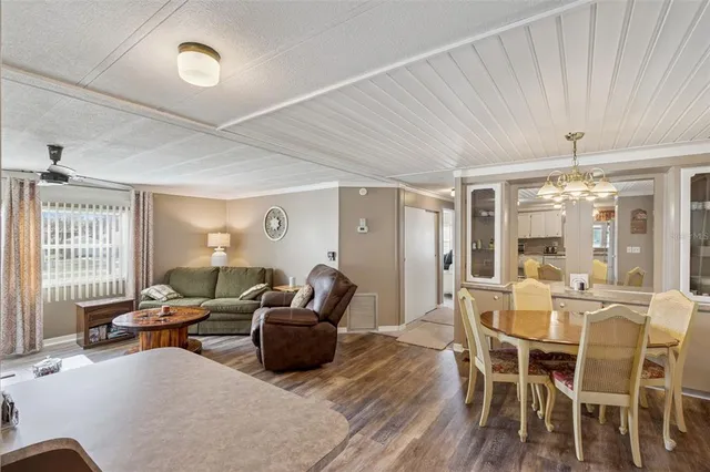 a living room with furniture wooden floor and a chandelier