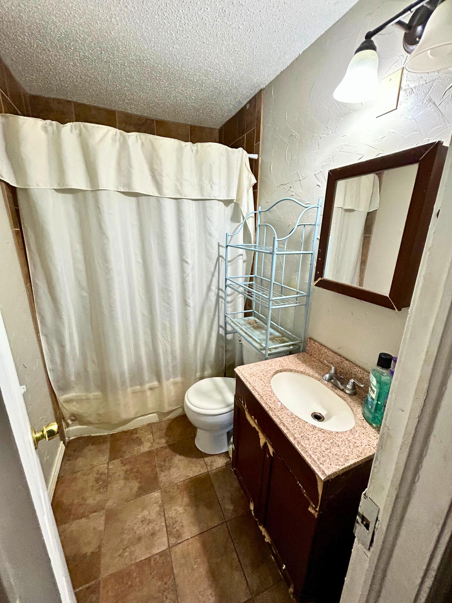 2205 39th Street Lubbock, TX 79412 - Photo 5 of 7 a bathroom with a sink a toilet and shower