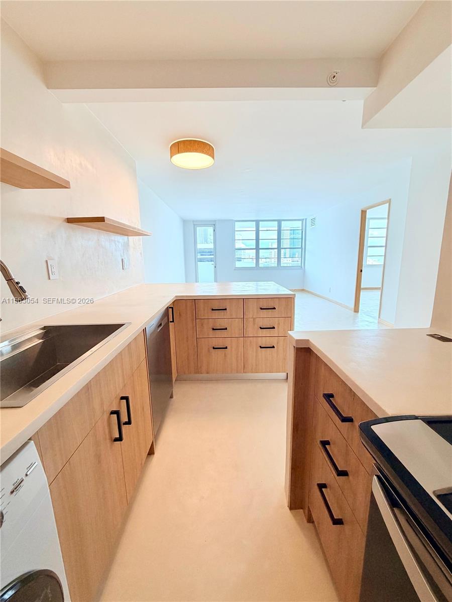100 Lincoln Road, Unit 1241 Miami Beach, FL 33139 - Photo 6 of 18 a kitchen with stainless steel appliances a sink stove and cabinets