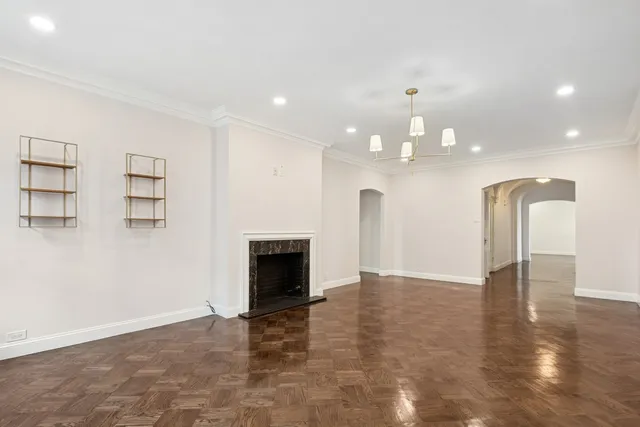 a view of an empty room with a kitchen