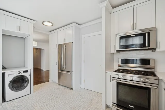 a kitchen with cabinets and steel stainless steel appliances
