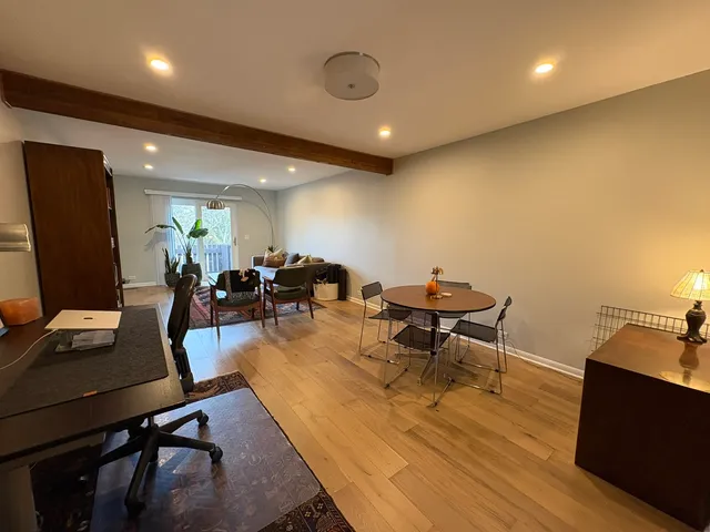 a living room with furniture a rug and a flat screen tv