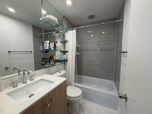 a bathroom with a sink toilet and shower
