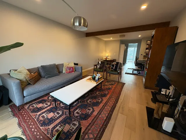 a living room with furniture and wooden floor