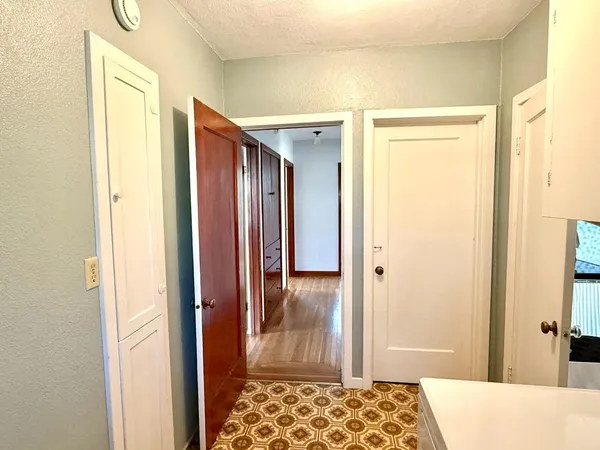 a view of a hallway with a wooden door