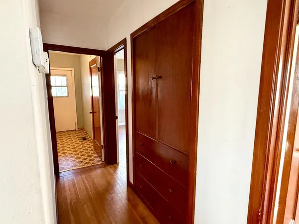 a view of walk in closet with wooden floor