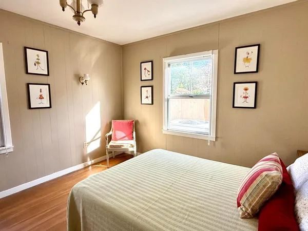 a bedroom with bed and a window