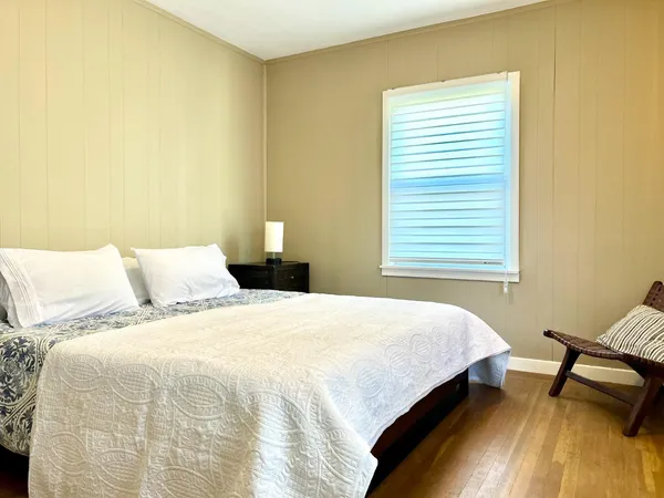 a bedroom with a bed and a chair