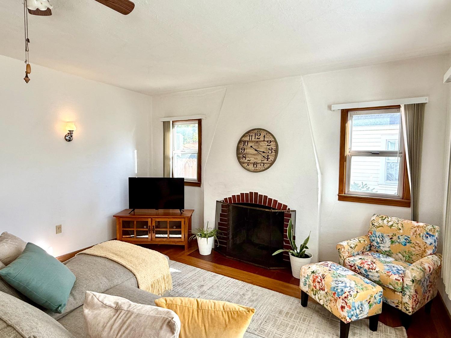 646 F Street Davis, CA 95616 - Photo 4 of 33 a living room with furniture a flat screen tv and a fireplace