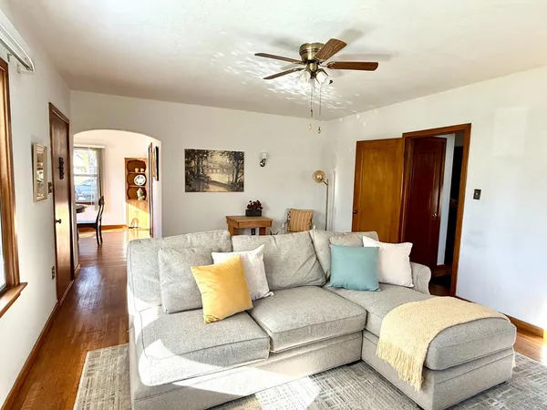 a living room with furniture and a view of bedroom