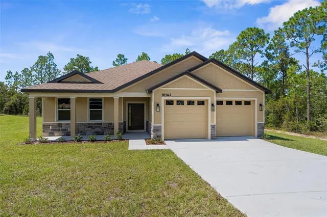 a front view of a house with a yard and porch