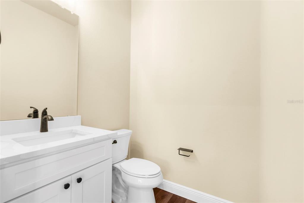 16143 Penn State Road Weeki Wachee, FL 34614 - Photo 13 of 45 a bathroom with a sink a toilet and a mirror