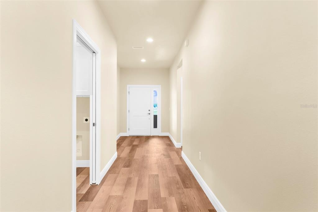 16143 Penn State Road Weeki Wachee, FL 34614 - Photo 22 of 45 a view of a hallway with wooden floor