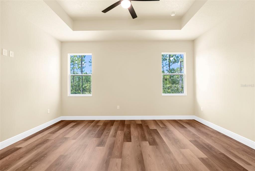 16143 Penn State Road Weeki Wachee, FL 34614 - Photo 23 of 45 an empty room with a hardwood and windows